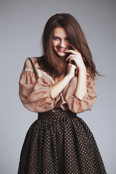 Beautiful girl in fashionable clothes. Studio portrait. romantic - Fotó, kép