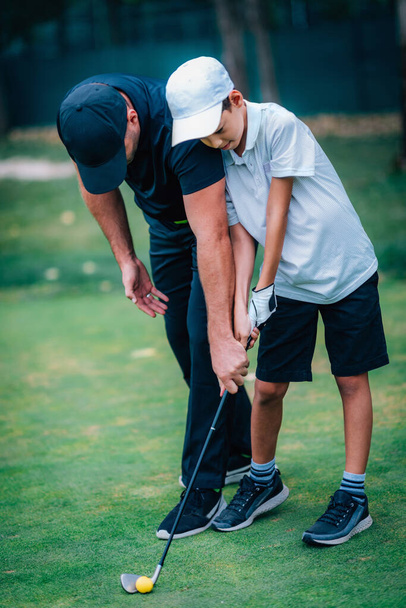 Golf  Personal Training. Golf Instructor Teaching Young Boy How to Play Golf.   - Fotoğraf, Görsel