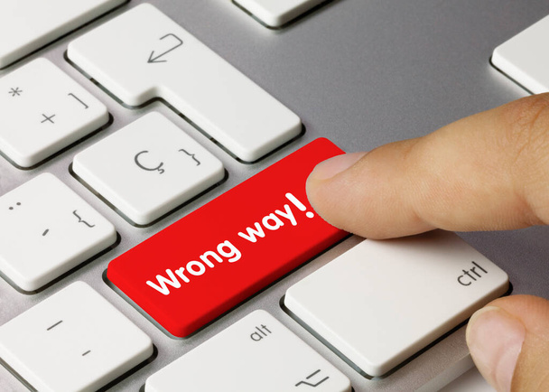 Wrong way Written on Red Key of Metallic Keyboard. Finger pressing key. - Photo, Image