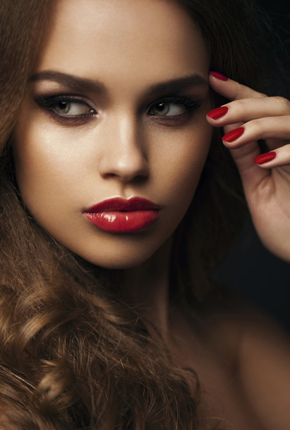 Portrait of beautiful girl with red lips, red manicure. Close up - Foto, Imagem
