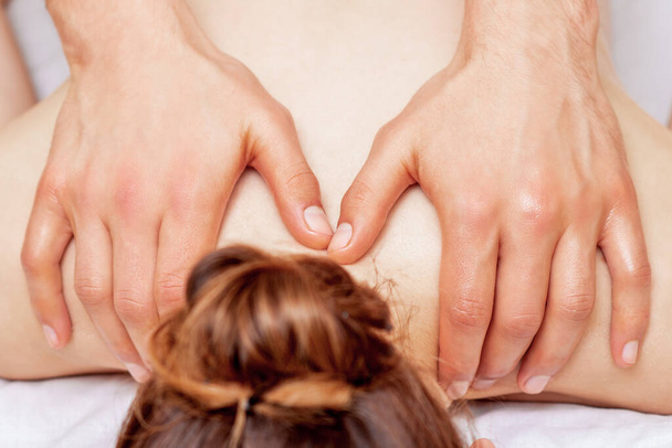 Shoulder massage of woman by hands of massage therapist, close up. - Photo, Image