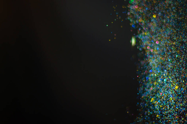 Fond abstrait avec des particules multicolores bokeh défocalisées scintillantes - Photo, image