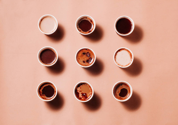 Modèle géométrique de tasses à café avec différents types de café, cappuccino et macchiato sur fond beige. Vue de dessus, plan plat. - Photo, image