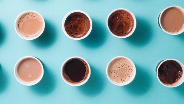 Lots of coffee cups with different types of coffee, cappuccino and macchiato on blue background. Top view, flat lay. Horizontal banner. - Photo, Image
