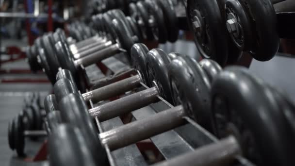 Shooting of rack with dumbbells in fitness gym - Footage, Video