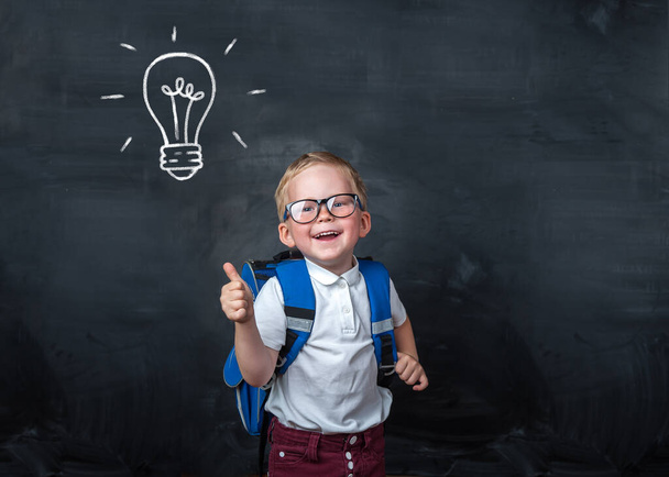 Excellent idea, kid with illustrated bulb above his head. Back to school - Zdjęcie, obraz