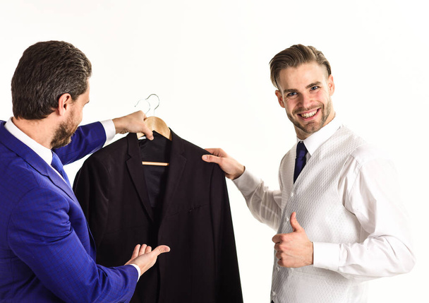 Men in business clothes holding jacket on hanger - Valokuva, kuva