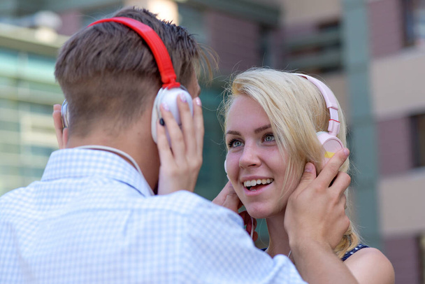 Couple in love listening music in headphones. - Foto, Bild
