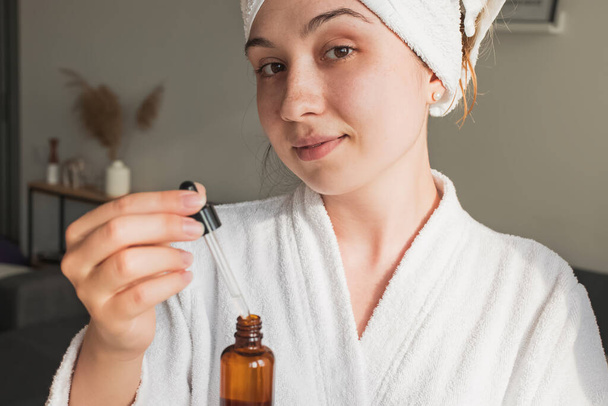 Young woman going to apply skincare product - Foto, afbeelding