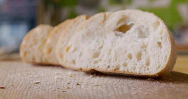 Freshly baked cut bread on rustic kitchen table, close up - Footage, Video