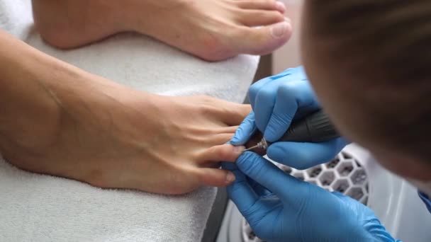 Pedicure process. Home salon pedicure. Foot care treatment and nail. The process of professional pedicures. Master in blue gloves make pedicure with manicure  machine.     - Footage, Video