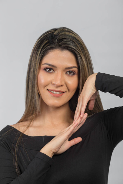 retrato de una mujer latina con las manos en su cuello - Foto, immagini