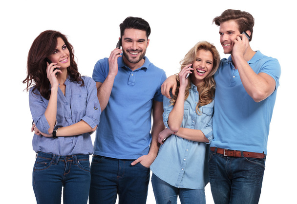 happy group of casual people talking on their phones - Фото, зображення