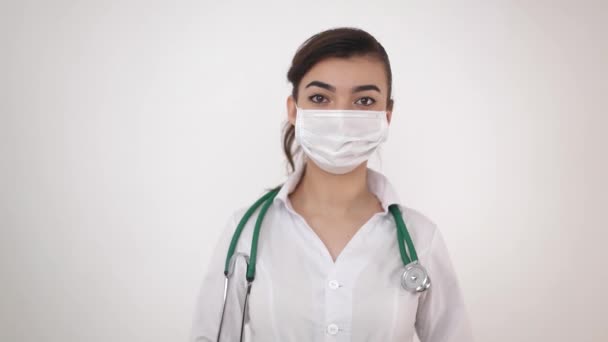 A girl doctor in a medical mask that holds a syringe with vaccination against coronavirus (COVID-19). - Felvétel, videó