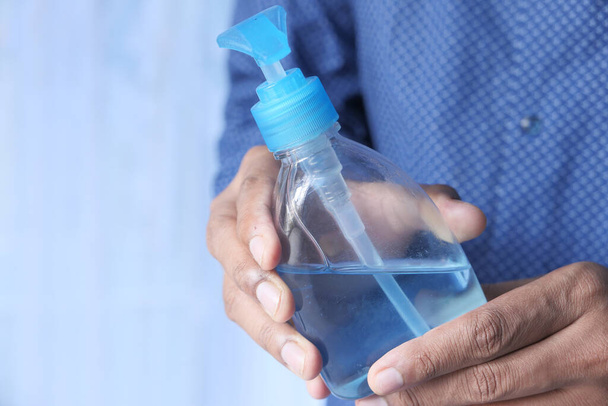 close up of man hand holding sanitizer gel with copy space  - Photo, image