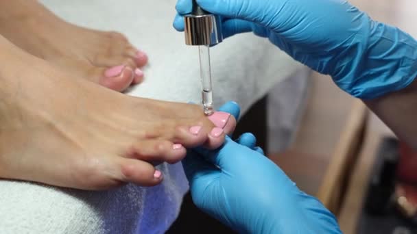 Pedicure process. Home salon pedicure. Foot care treatment and nail. The process of professional pedicures. Master in blue gloves make pedicure with manicure  machine.         - Footage, Video