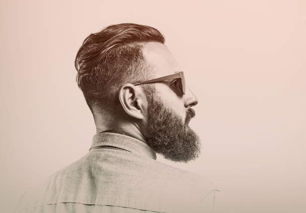Black and white portrait of bearded man in glasses on toned background. - Photo, Image