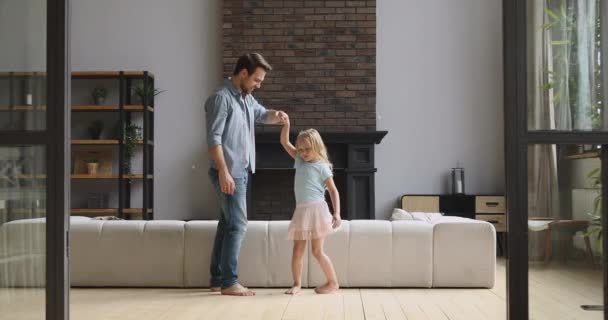 Loving dad kissing hand dancing with child daughter at home - Filmmaterial, Video