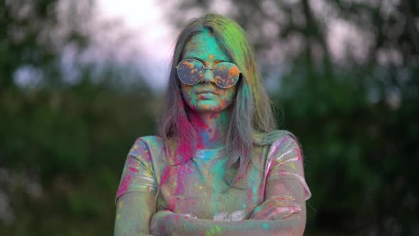 Portrait of boy standing being covered in coloured powder at holi festival - Footage, Video