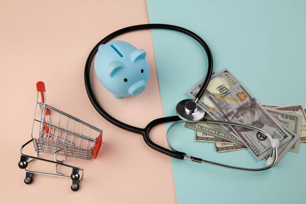 Stethoscope,piggy and money - a business concept in medicine - Photo, Image