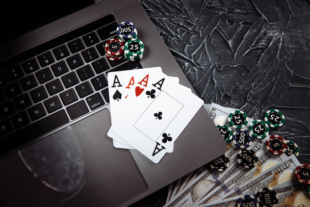 Κάρτες πόκερ και στοίβες μάρκες πόκερ σε έναν φορητό υπολογιστή. Πόκερ online έννοια - Φωτογραφία, εικόνα