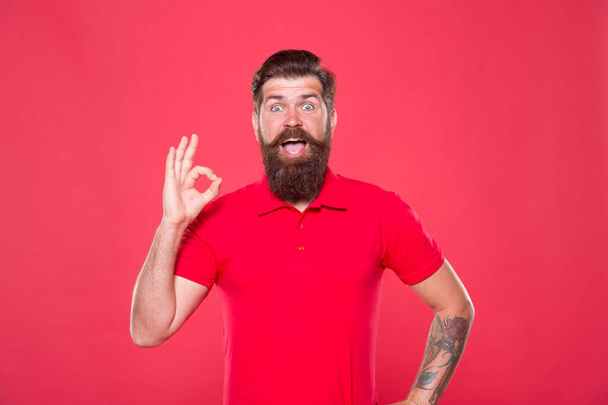 Best haircut here. Promoting barber services. Portrait of bearded man red background. Brutal guy with mustache. Hipster with beard. Hairdresser salon. Brutality and confidence. Barbershop model - Photo, image