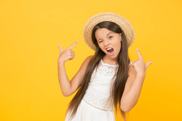 Enjoying warm day. happy childhood. cool little girl wear straw hat. beach fashion for kids. small child on yellow background. holiday joy and activity. beauty. long-awaited summer vacation - Foto, Bild