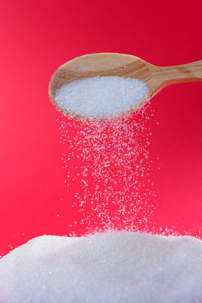 Sugar on red background - Photo, Image