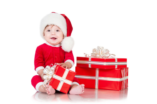 Cheerful little Santa Claus with presents. Isolated on white bac - Φωτογραφία, εικόνα