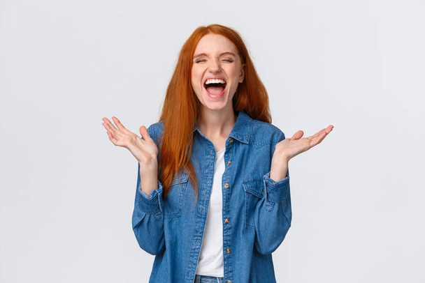 Lol so funny. Amused and carefree pretty redhead female student clap hands, applause with closed eyes as laughing out loud, having fun, hear hilarious joke, standing white background - Φωτογραφία, εικόνα