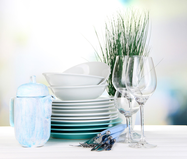 Clean dishes on table on bright background - Fotografie, Obrázek