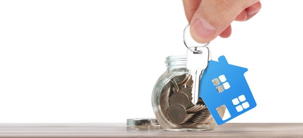 Real estate agent handing over house keys in a hand - 写真・画像