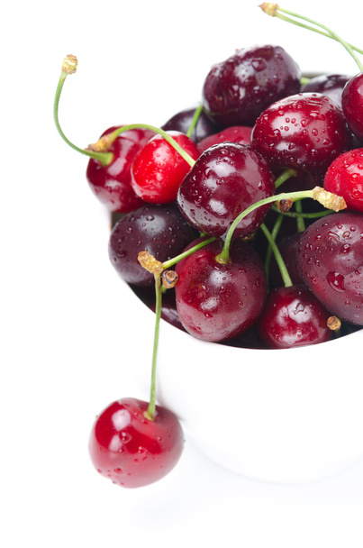 Bowl of fresh cherries on a white background, selective focus - Foto, Imagen
