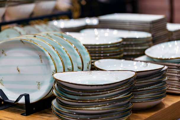 Luxury white ceramic plates on a table is the background selective focus and shallow depth of field - Photo, Image