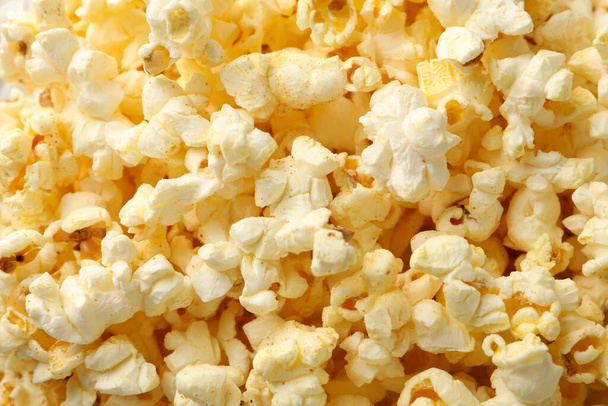 Tasty popcorn on whole background. Food for watching cinema - Foto, Imagen