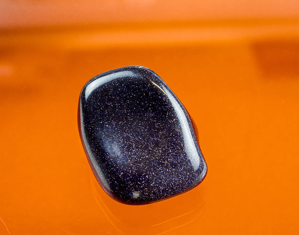 A darkblue aventurine glass with a sparkling blue surface. - Photo, Image