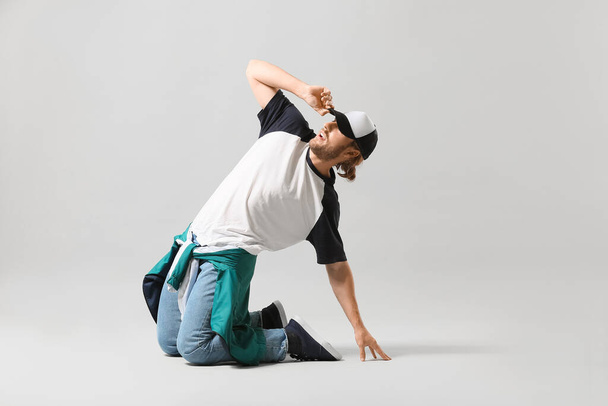 Male hip-hop dancer on light background - Valokuva, kuva