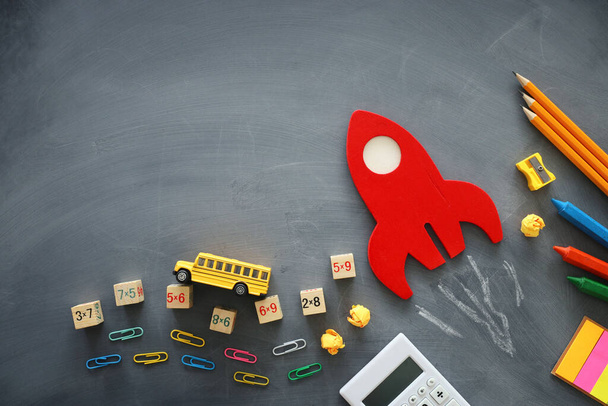 education. Back to school concept. wooden red rocket over blackboard background. top view, flat lay - 写真・画像