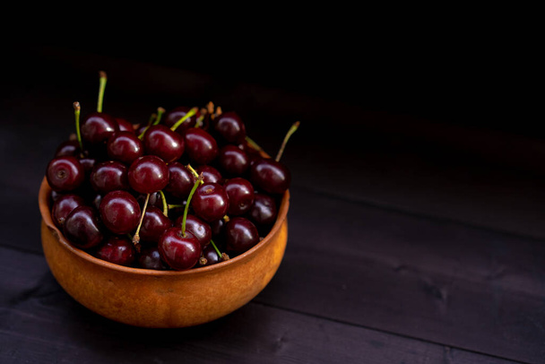 Ripe cherry on a wooden background - Fotoğraf, Görsel