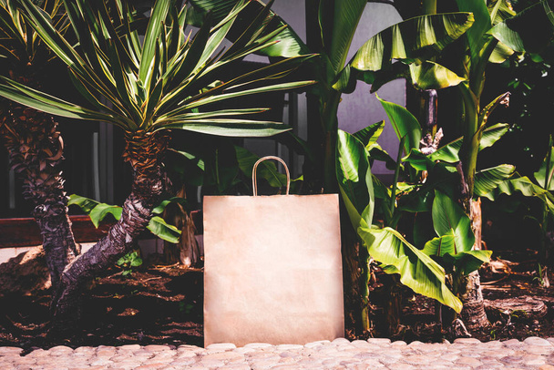 Paper bag among plants. - Foto, Imagen