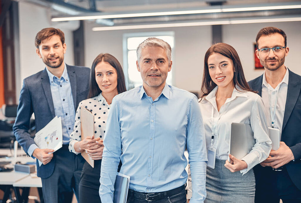 Handsome adult man with his professional team in the office - 写真・画像