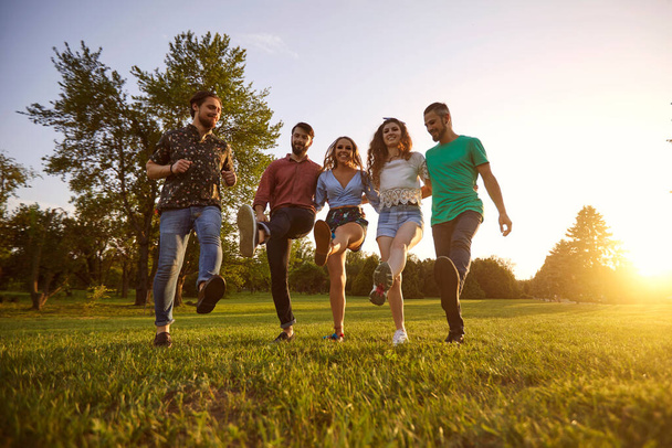 Group of young hipster friends having fun and dancing in countryside. Men and women having great time together outdoors - Fotoğraf, Görsel