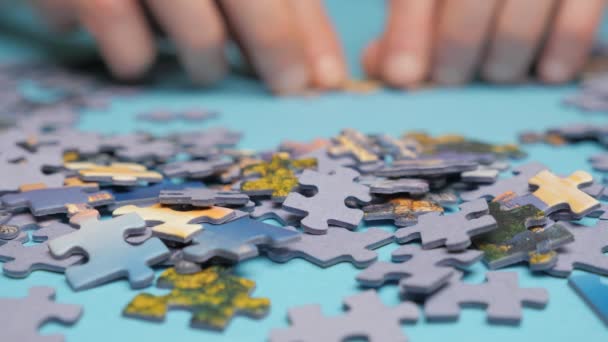 Assembling jigsaw puzzle. Hand matching jigsaw halves. Leisure activity. Achieving step by step Love concept. Engaging in successful work finding business solution, corporate unity - Footage, Video