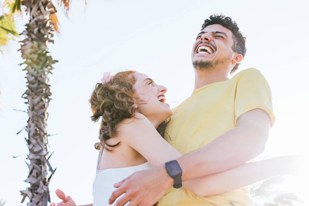 joven pareja abrazo mientras sonríe en verano
 - Foto, imagen