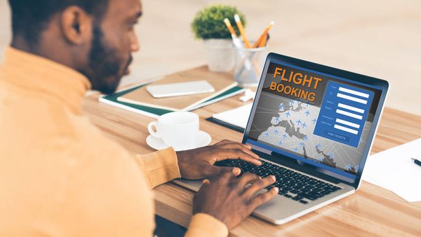 African Businessman At Laptop Booking Flight Sitting In Office, Panorama - Photo, Image