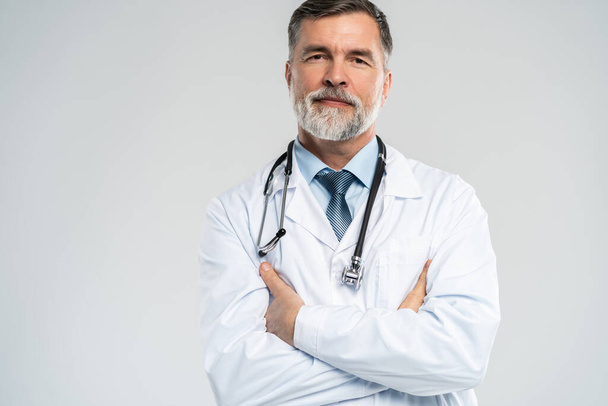 Cheerful mature doctor posing and smiling at camera, healthcare and medicine. - 写真・画像