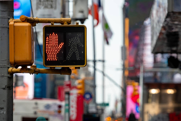 Stop, dont walk red hand traffic signal for pedestrians in Manhattan, defocused street background, New York City, USA - Photo, image