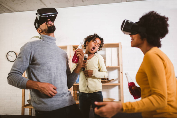 Happy black family at home. Dad, mom and daughter playing virtual reality.  - Photo, Image