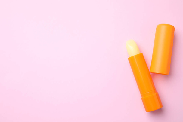 Hygienic lipsticks on pink background, flat lay. Space for text - Fotó, kép