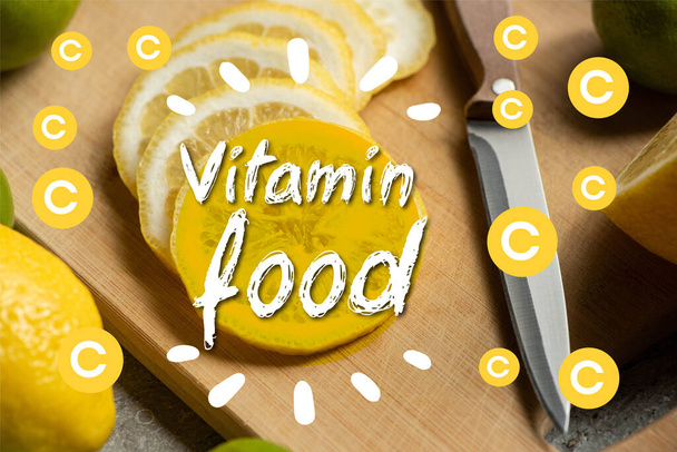 close up view of sliced lemon on wooden cutting board with knife, vitamin food illustration - Foto, Imagen